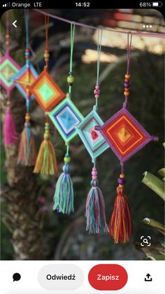 the mobile phone is displaying an image of colorful tassels hanging from a tree