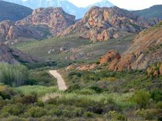 a dirt road in the middle of some mountains