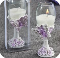 two glass vases with candles in them