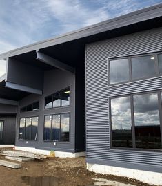 a large building that has some windows on the side of it and is under construction