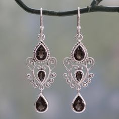 Cast your own spell of enchantment with these mesmerizing earrings from India's Shubhra Singh. Elaborate heart-shaped motifs in sterling silver are flanked top and bottom by teardrops of smoky quartz. The dangle earrings feature over 3 carats of the dusky gemstone including smaller teardrops at the hearts' centers. The earrings sway on sterling silver hooks..925 Sterling silver Shiney Things, Baroque Jewelry, Enchanted Princess, Jewelry Wishlist, Soldered Jewelry, Queen Jewelry, Magical Jewelry, Scroll Design, Celtic Jewelry