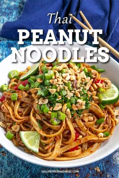 a bowl filled with noodles and vegetables on top of a blue table