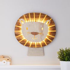 a wooden clock that has a light up face on it's face and is shaped like a lion