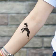 a woman's arm with a tattoo on it that has an image of a dog