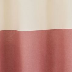 a close up view of a pink and white curtain