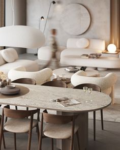 a living room filled with lots of furniture and white couches next to a table