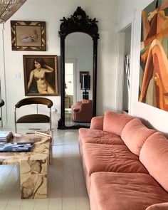 a living room filled with furniture and paintings