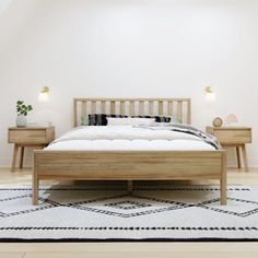 a bed sitting on top of a white rug next to two nightstands in a bedroom