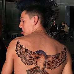 a man with an eagle tattoo on his back