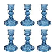 six blue glass candlesticks sitting next to each other