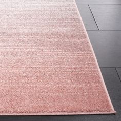 a pink rug on the floor in a room