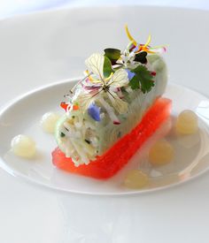 a white plate topped with food and garnish on top of it's side