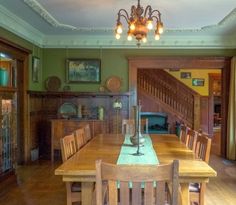 a dining room table with chairs and a chandelier