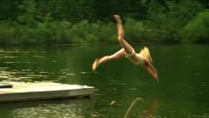 a person jumping into the water from a dock