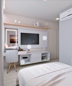 a bedroom with white furniture and a flat screen tv mounted on the wall above it