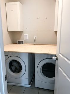 a washer and dryer in a small room next to an open closet door