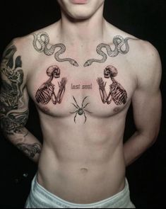 a shirtless man with tattoos on his chest and hands in the shape of two skeletons