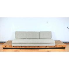 a couch sitting on top of a wooden platform