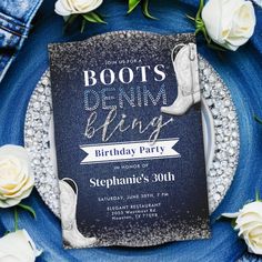 a blue plate with some white flowers on it and a card that says boots bring bling