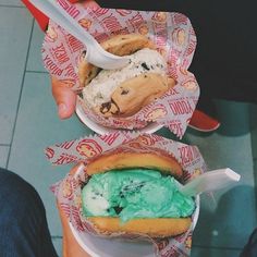 three baskets filled with ice cream and cookies on top of each other in paper wrappers