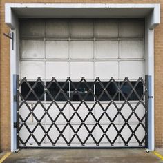 an open garage door with bars on the side