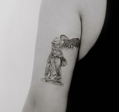 a black and white photo of a statue with an angel on it's arm