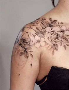 a woman's shoulder with flowers on it