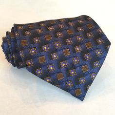 Robert Talbott for Nordstrom Silk Necktie Navy blue, with gold and yellow, in a geometric pattern. Imported silk. Hand sewn. Made in the USA. 4" wide 59" long Professional Blue Suit And Tie Accessories For Business, Classic Blue Neckwear For Business, Classic Blue Business Neckwear, Blue Semi-formal Necktie, Blue Semi-formal Standard Tie, Classic Blue Neckwear For Semi-formal Occasions, Blue Semi-formal Neckwear, Blue Standard Tie For Formal Occasions, Classic Blue Neckwear For Office