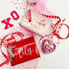 valentine's day gifts are laid out on a table with confetti and decorations