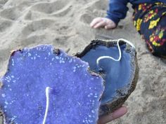 a person holding an object in the sand