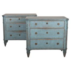 pair of blue painted chests with brass knobs