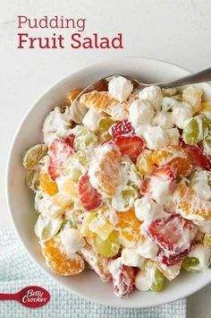 a white bowl filled with fruit salad on top of a table