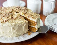 a cake with white frosting and crumbs on it sitting on a plate