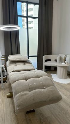 a bed sitting on top of a hard wood floor next to a window in a room