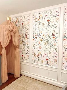 a living room with floral wallpaper and curtains