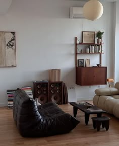 a living room filled with furniture and a book shelf