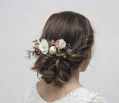 a woman with flowers in her hair is wearing a flowered headpiece on her wedding day