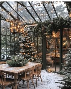 a dining room table covered in snow with christmas lights hanging from the ceiling and windows