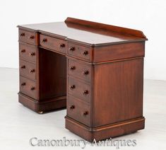 an antique wooden desk with drawers on it