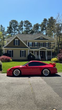 a red sports car parked in front of a house