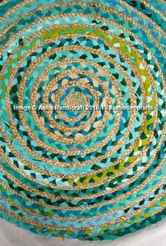 a blue, green and beige rug with circles on it