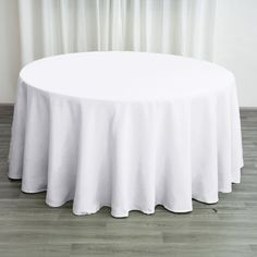 a round table with white cloth on it