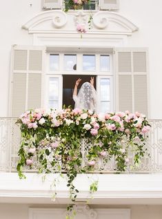 a bride standing on the balcony of a building