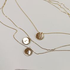 Delicate gold initial disc necklace. Personalized hand stamped gold filled or silver circle necklace. Perfect everyday necklace and great for layering with longer chains or a sweet gift for moms, sisters or friends. *** 14k gold filled, rose gold filled or sterling silver disc. *** Initials stamped by hand. *** Satin finish, hammered or hammered edge. ***Chain is 16"to18"adjustable Disc measurement : 1/2" inches (13mm) diameter. You can choose material ( sterling silver , yellow gold filled or r Dainty Initial Pendant Necklace For Layering, Minimalist Initial Pendant Charm Necklace For Layering, Minimalist Layered Necklace With Adjustable Chain, Gold Layered Necklace With Round Pendant For Everyday, Everyday Initial Necklace With Adjustable Chain And Round Pendant, Dainty 14k Gold Round Disc Charm Necklace, Dainty Coin Necklace With Delicate Chain For Everyday, Sterling Silver Charm Necklaces For Layering, Sterling Silver Round Charm Necklaces For Layering