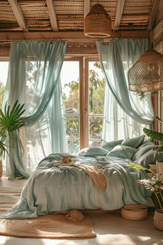 a bed sitting in a bedroom next to a window covered in blue drapes and curtains