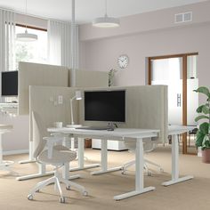 a computer desk with two monitors on it and a chair in front of the monitor