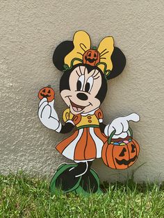 a mickey mouse with pumpkins in his hand