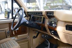 the interior of an old car with wood trim and dash board, steering wheel and dashboard