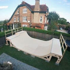 there is a large white tarp on the ground in front of a house with an attached ramp