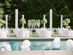 an outdoor wedding set up by the pool